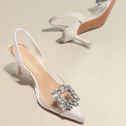 Stylish transparent slim heel sandals with jeweled embellishment for women, perfect for summer fashion events.