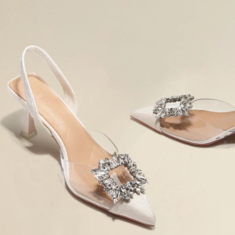 Elegant white transparent sandals with bling buckle and slim heel for women, perfect for summer occasions.
