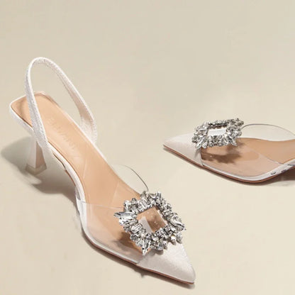 Elegant white transparent sandals with bling buckle and slim heel for women, perfect for summer occasions.